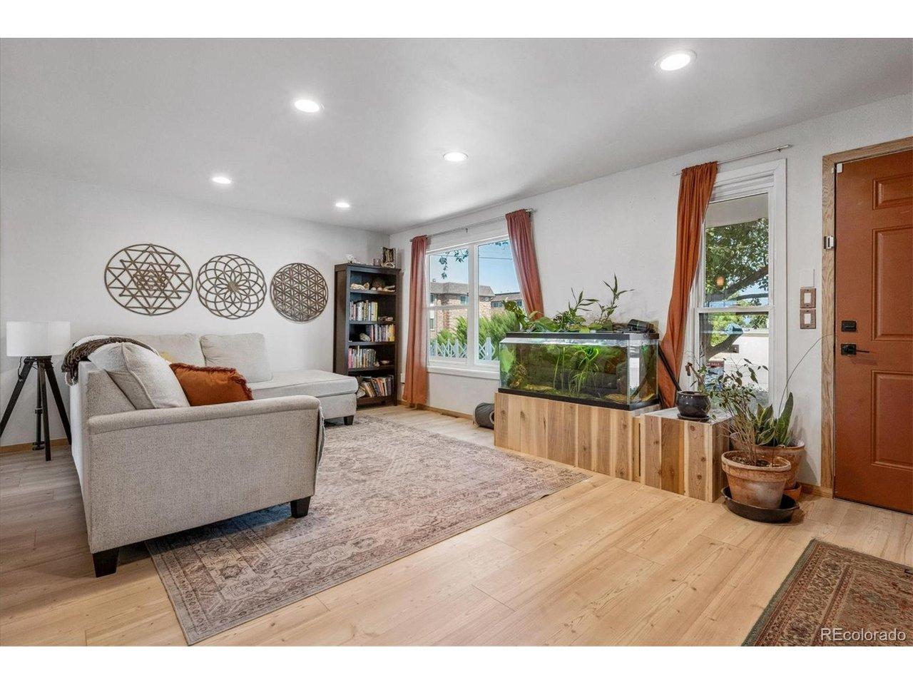 Image 4: Living Room with Natural Light from Large Windows