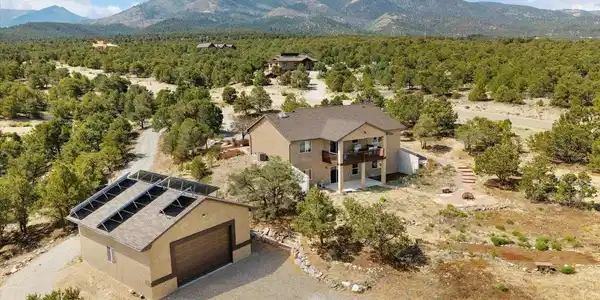 Image 3: Aerial view of the home and detached garage from the back