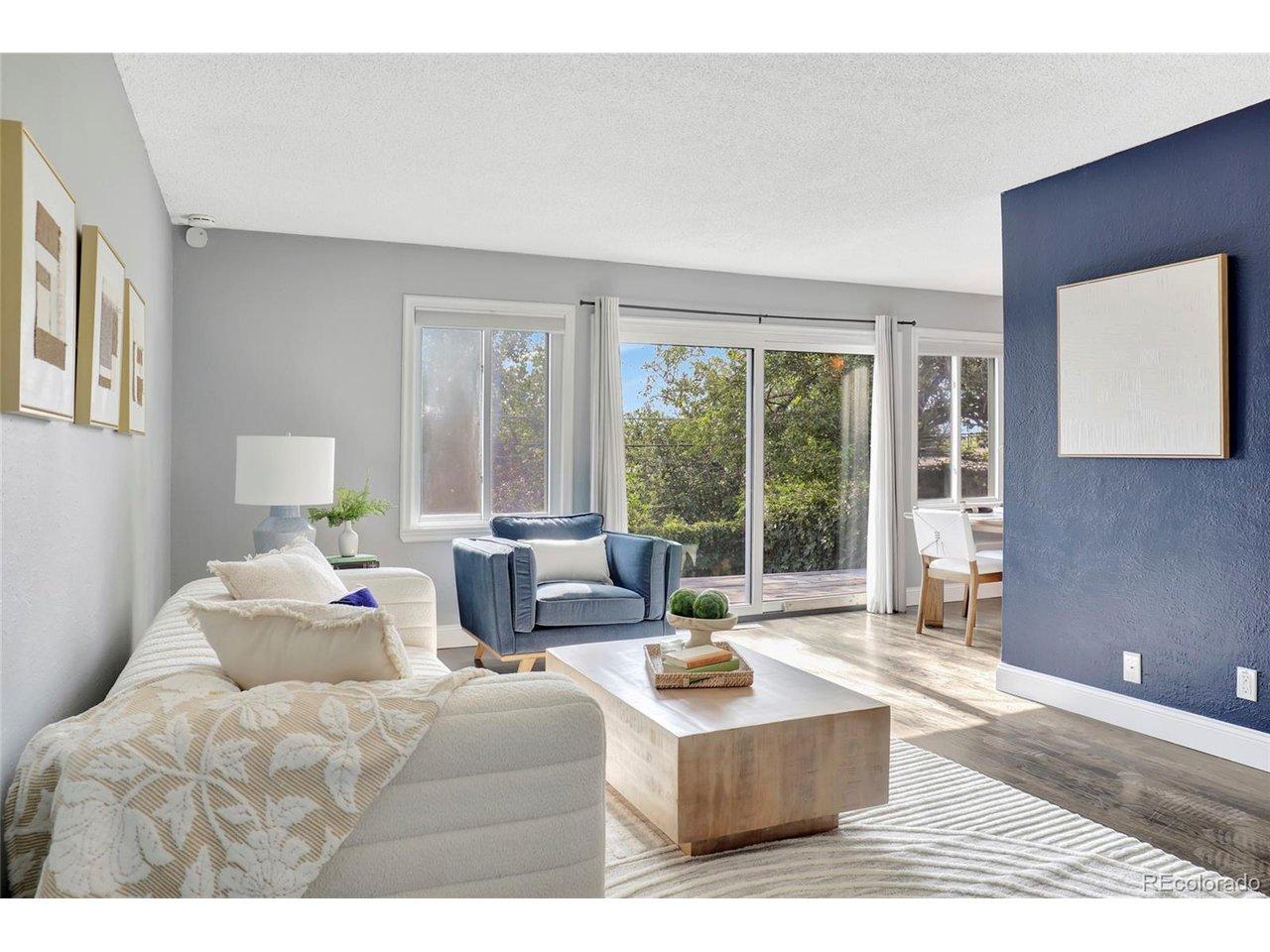 Image 3: Light-filled living room featuring expansive windows, durable flooring, and an open flow into the dining area. Image 3: Light-filled living room featuring expansive windows, durable flooring, and an open flow into the dining area.