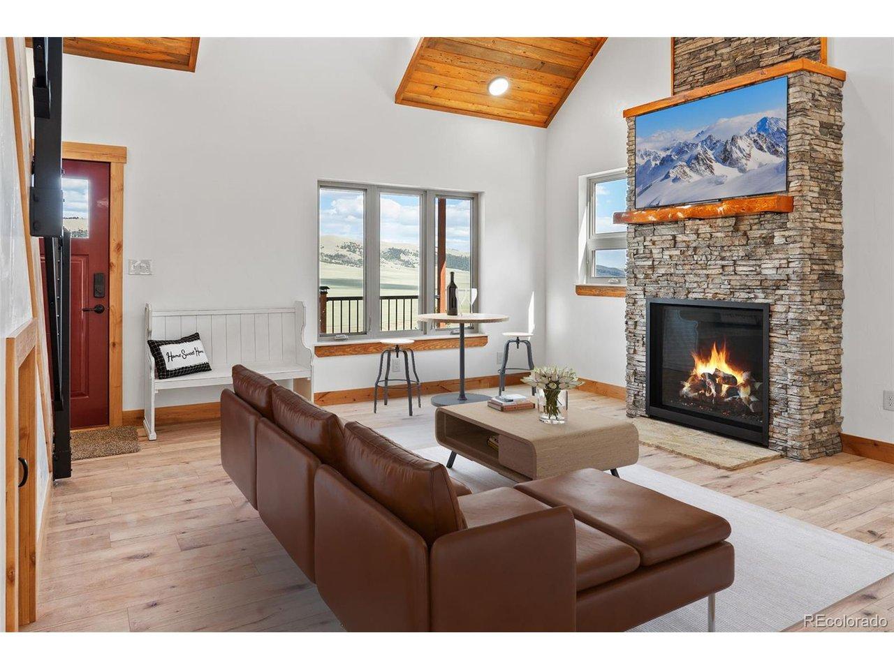 Image 3: Virtually staged Great Room with stone surround gas fireplace