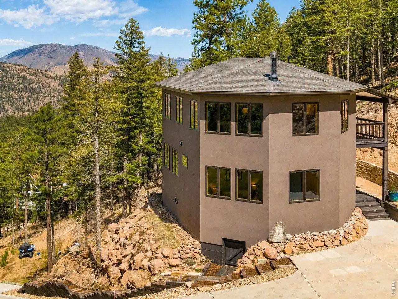 Image 1: Exterior view showcasing the home's mountain backdrop, forested privacy, and generous outdoor space. Image 1: Exterior view showcasing the home's mountain backdrop, forested privacy, and generous outdoor space.