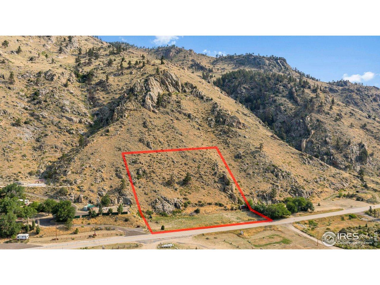 Image 1: Expansive property outlined against a dramatic mountain backdrop, showcasing the rugged terrain and natural slope of this scenic Bellvue property. Image 1: Expansive property outlined against a dramatic mountain backdrop, showcasing the rugged terrain and natural slope of this scenic Bellvue property.