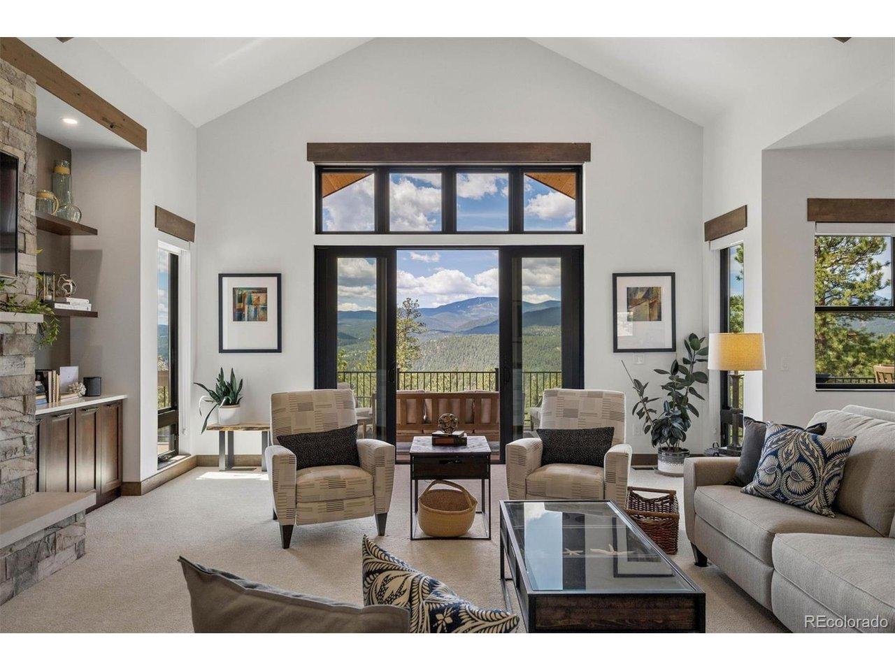 Image 2: Tall windows and glass sliders frame the lovely southern panoramic mountain views.