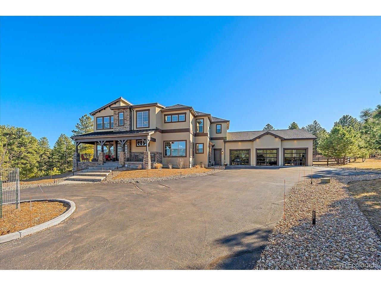 Image 3: Incredible curb appeal with the covered front porch and glass garage doors. Image 3: Incredible curb appeal with the covered front porch and glass garage doors.