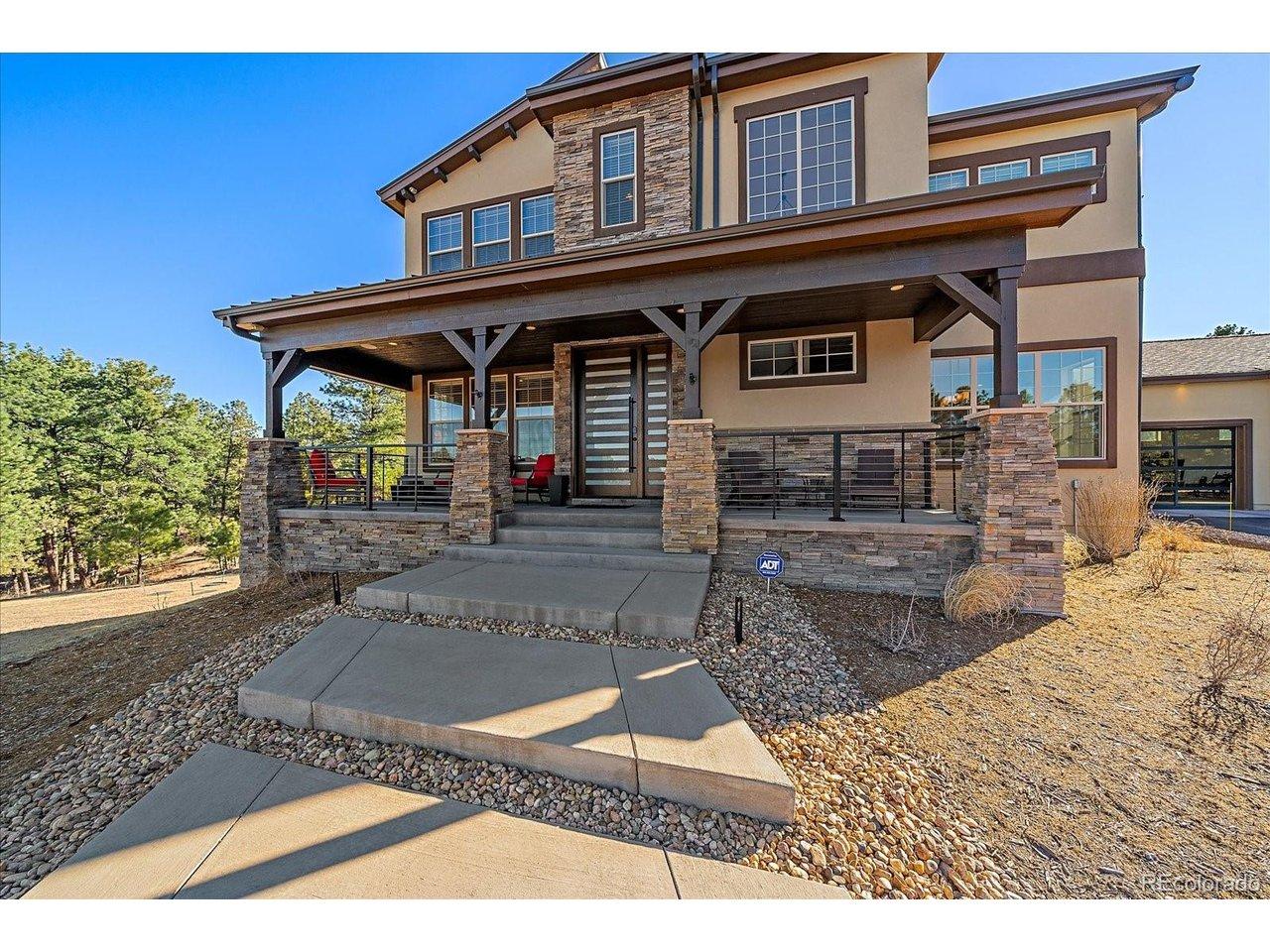 Image 4: Covered front deck with an incredible custom front door welcomes you home Image 4: Covered front deck with an incredible custom front door welcomes you home