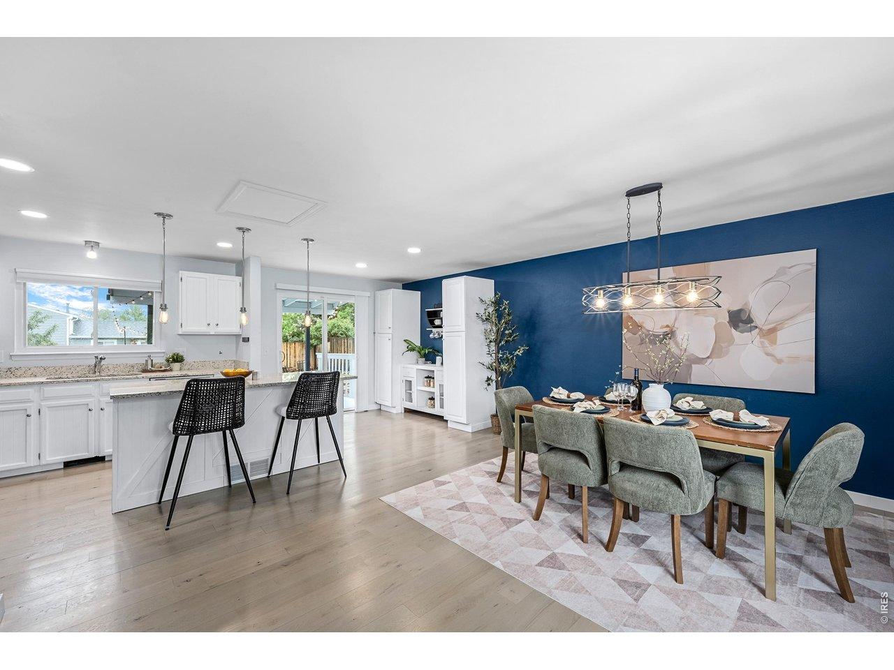 Image 2: The open-concept layout creates seamless indoor/outdoor flow between the kitchen, dining, living, and backyard spaces