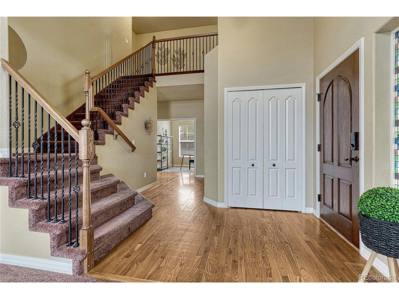 Image 4: Step inside to an open layout featuring hardwood floors and vaulted ceilings that immediately make the home feel expansive and deeply inviting