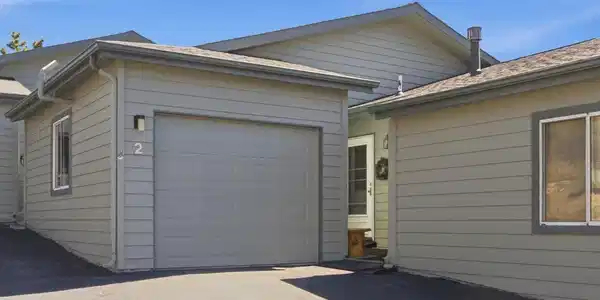 Image 2: Front of Condo with 1-car Garage