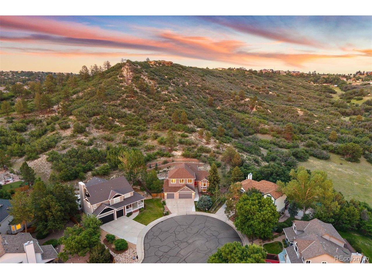 Image 3: Quiet cul-de-sac setting nestled against open hillside and natural open space, with generous lot sizes and mature trees throughout the neighborhood.
