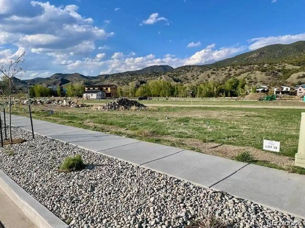 Image 1: Sidewalks and infrastructure are complete for this lot