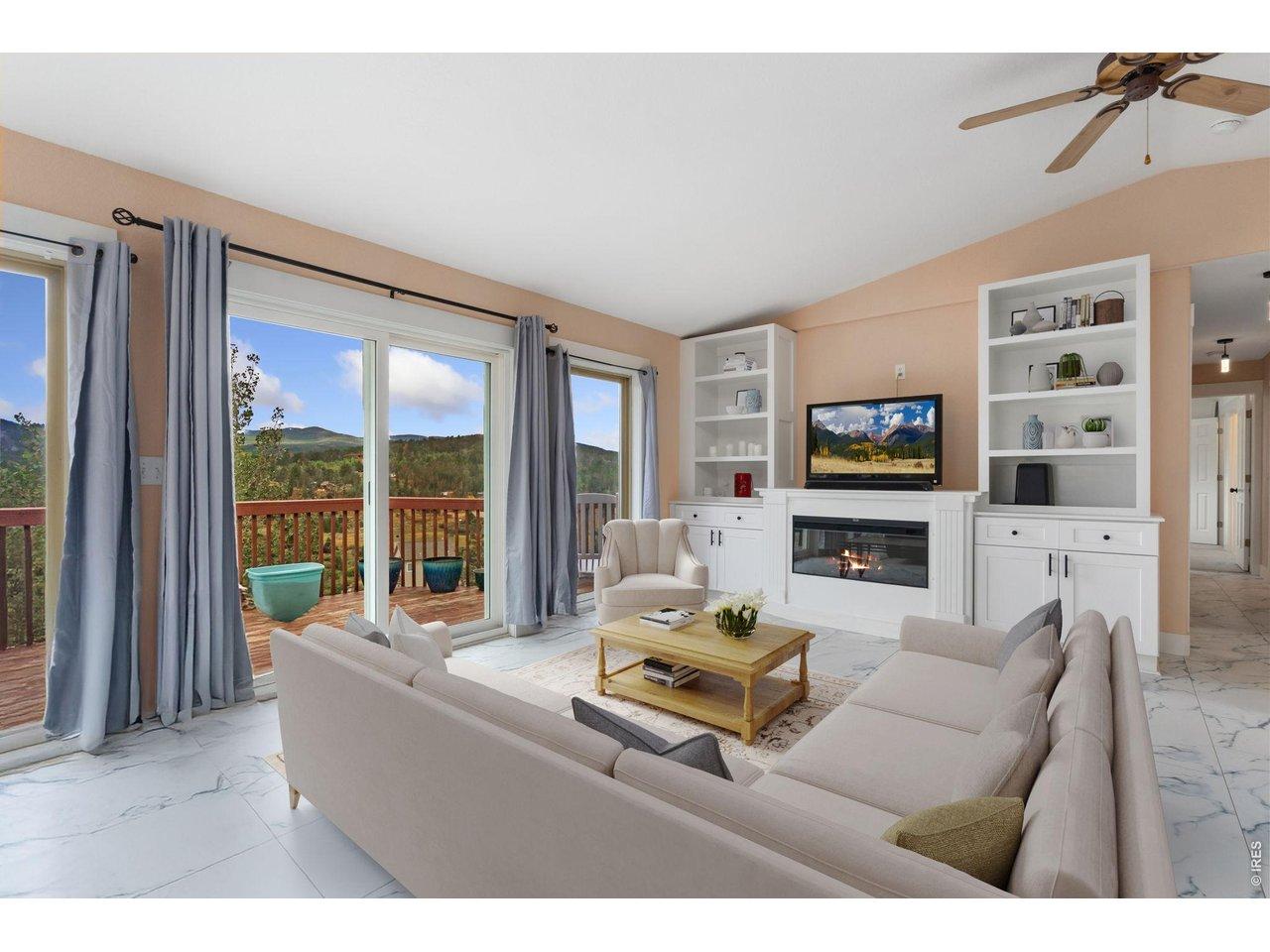 Image 3: Floor to ceiling windows/doors overlook the valley below. Built-in shelving & gas fireplace. (Furniture is virtually staged). Image 3: Floor to ceiling windows/doors overlook the valley below. Built-in shelving & gas fireplace. (Furniture is virtually staged).