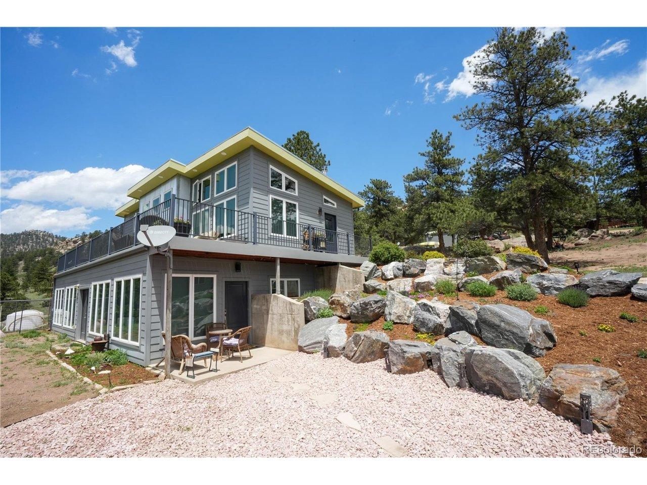 Image 4: Sunroom entry from lower level with Beautifully landscaped rock garden