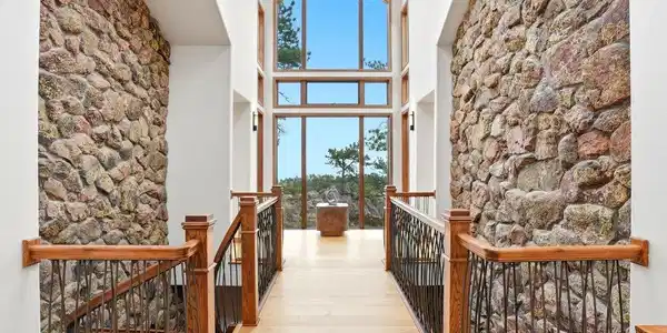 Image 4: Bring the outdoors in with stunning two story stone walls Image 4: Bring the outdoors in with stunning two story stone walls