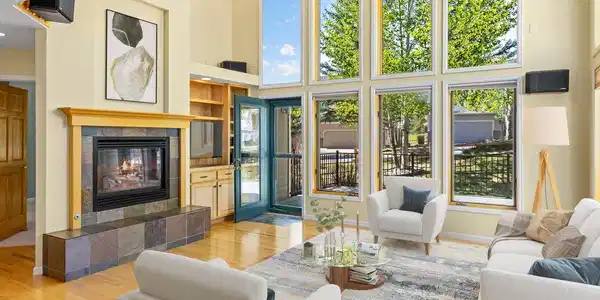 Image 2: Wall of windows and warm fireplace