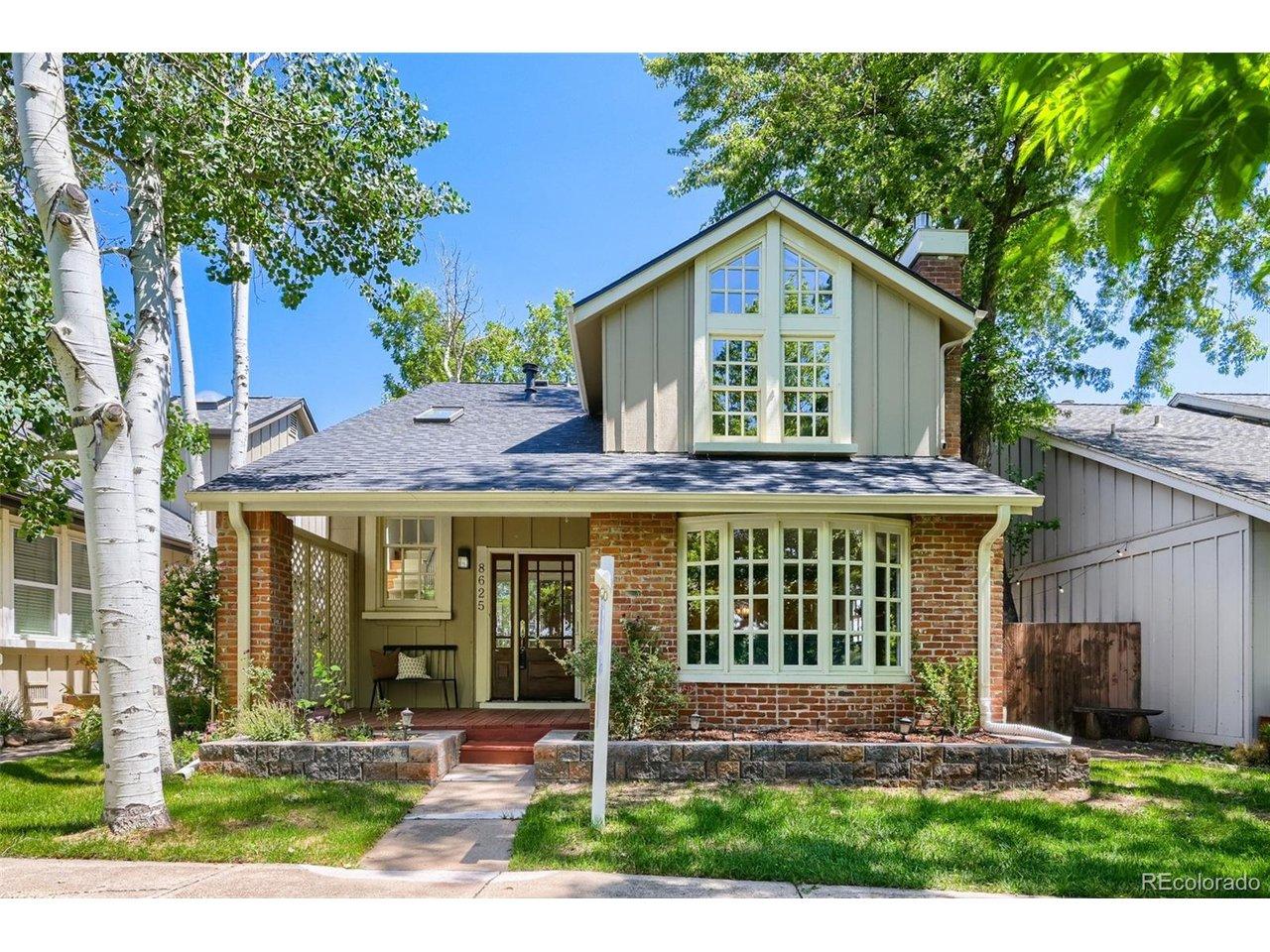 Image 1: Imagine starting your mornings with coffee on the porch overlooking the lake or watching sunsets from the flagstone patio on the right of the home.