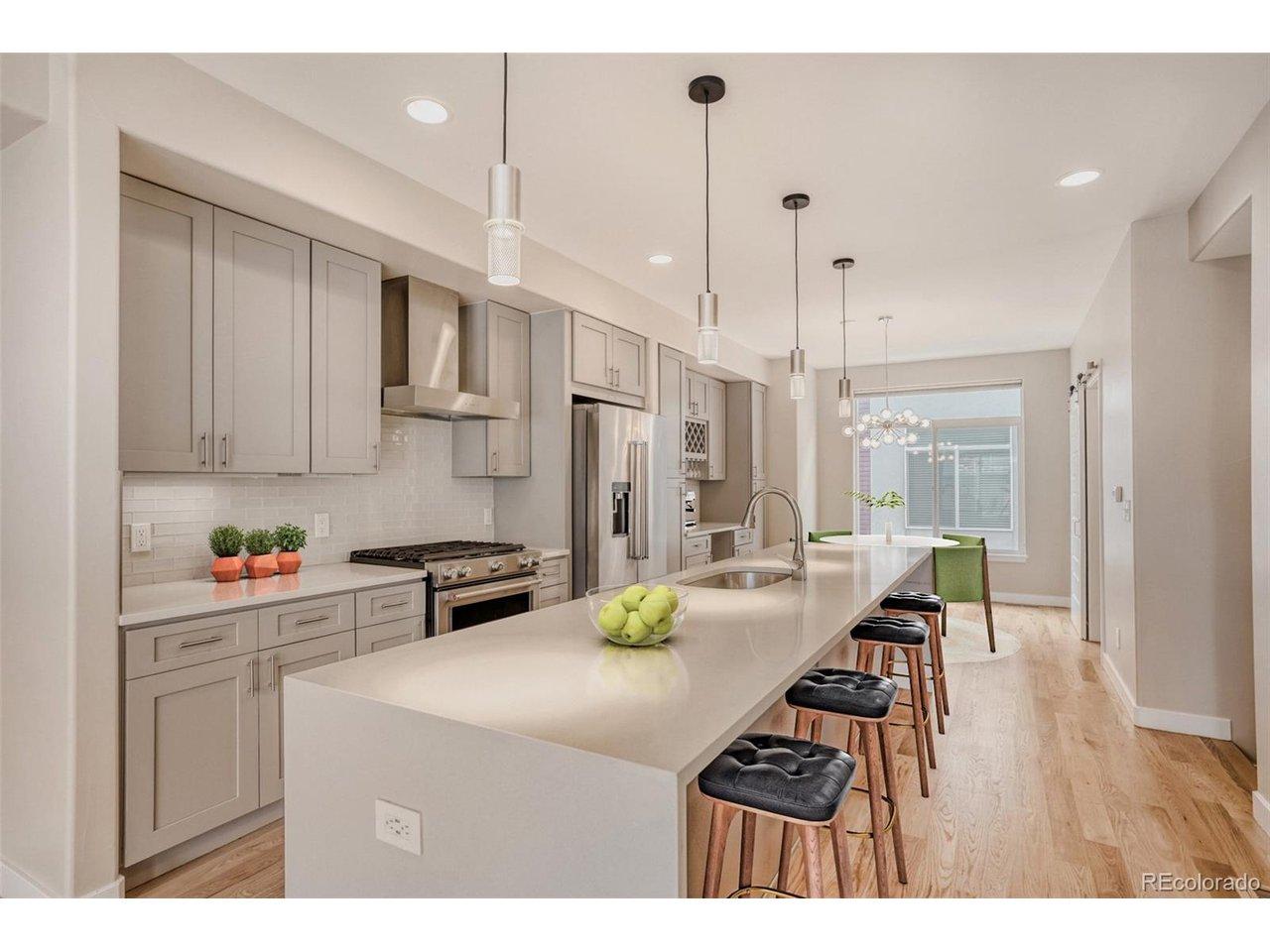 Image 4: Beautiful modern kitchen with quartz countertops, stainless steel appliances, stylish lighting & more (virtually staged) Image 4: Beautiful modern kitchen with quartz countertops, stainless steel appliances, stylish lighting & more (virtually staged)