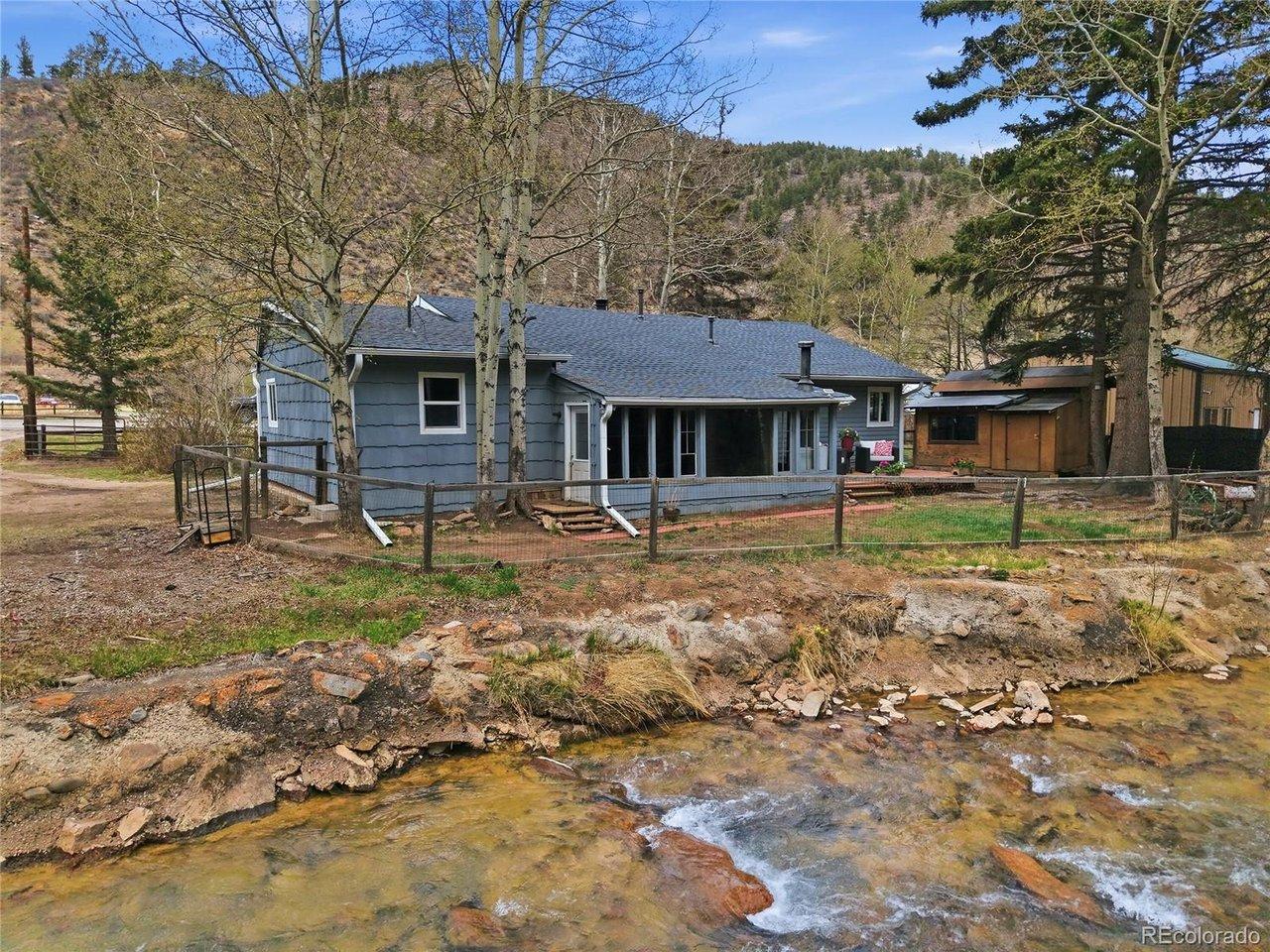 Image 2: View of home from above river Image 2: View of home from above river