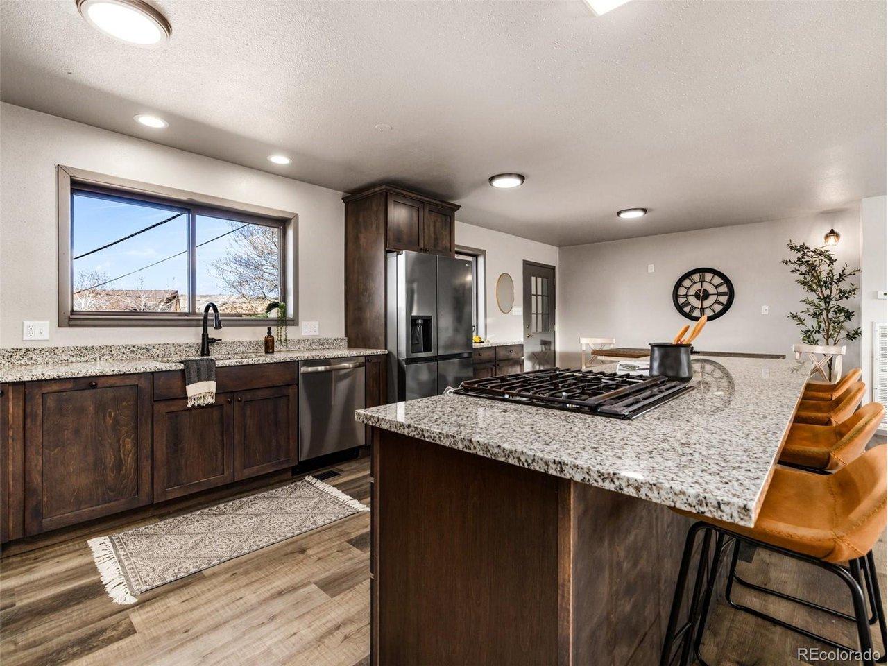 Image 4: Gourmet kitchen with granite counter tops, island, custom cabinets and LTV flooring Image 4: Gourmet kitchen with granite counter tops, island, custom cabinets and LTV flooring
