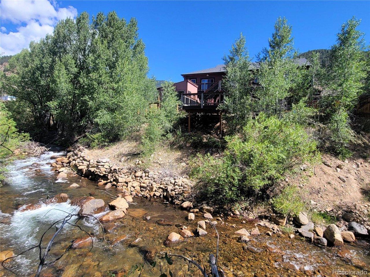 Image 2: Back of home and creek Image 2: Back of home and creek