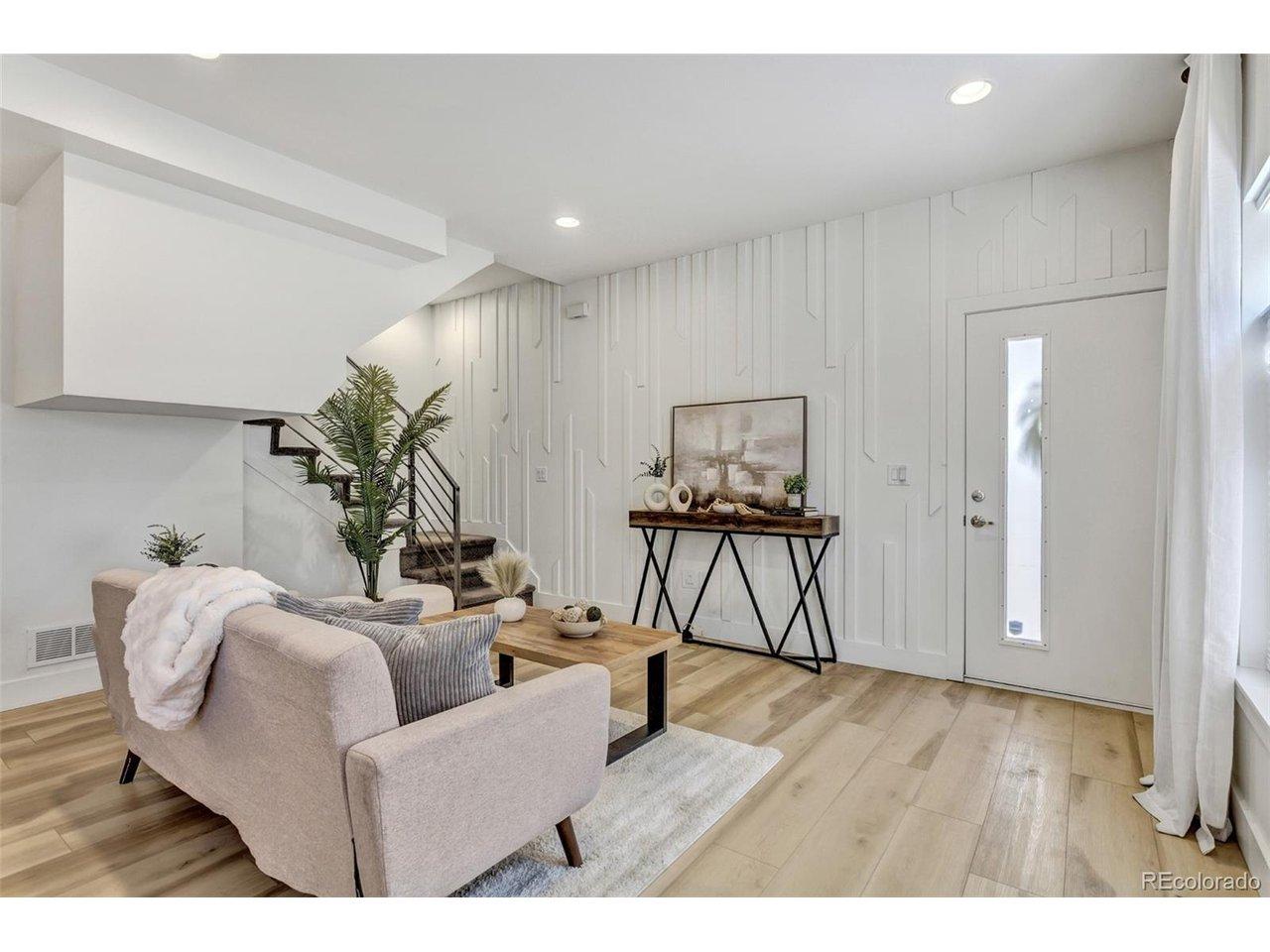 Image 3: Open-concept living room with abundant natural light and upgraded architectural wall detailing. Image 3: Open-concept living room with abundant natural light and upgraded architectural wall detailing.