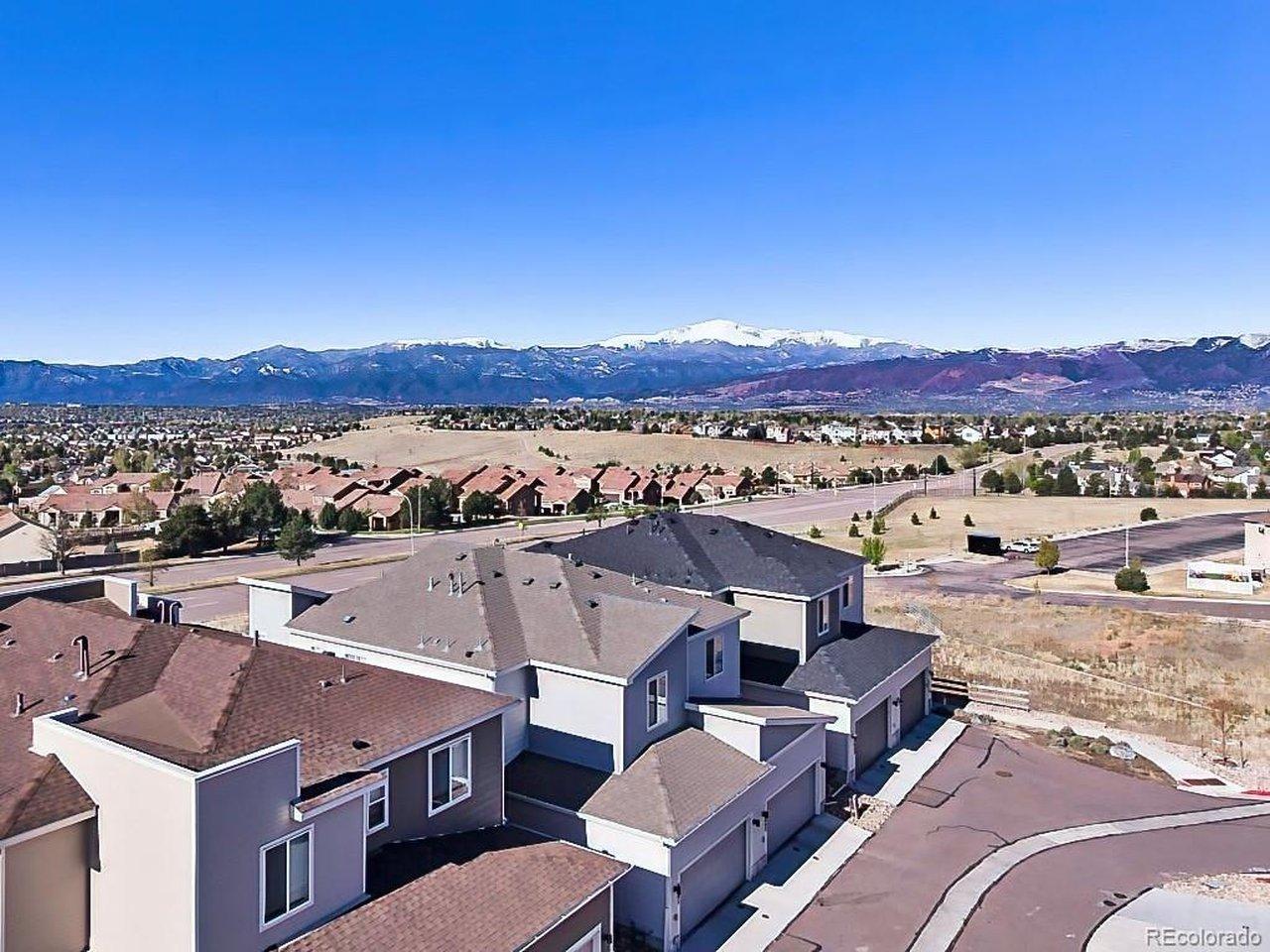Image 2: Elevated drone view showcasing the home's desirable location within a well-maintained neighborhood, complete with mountain backdrops and easy access to nearby amenities. Image 2: Elevated drone view showcasing the home's desirable location within a well-maintained neighborhood, complete with mountain backdrops and easy access to nearby amenities.