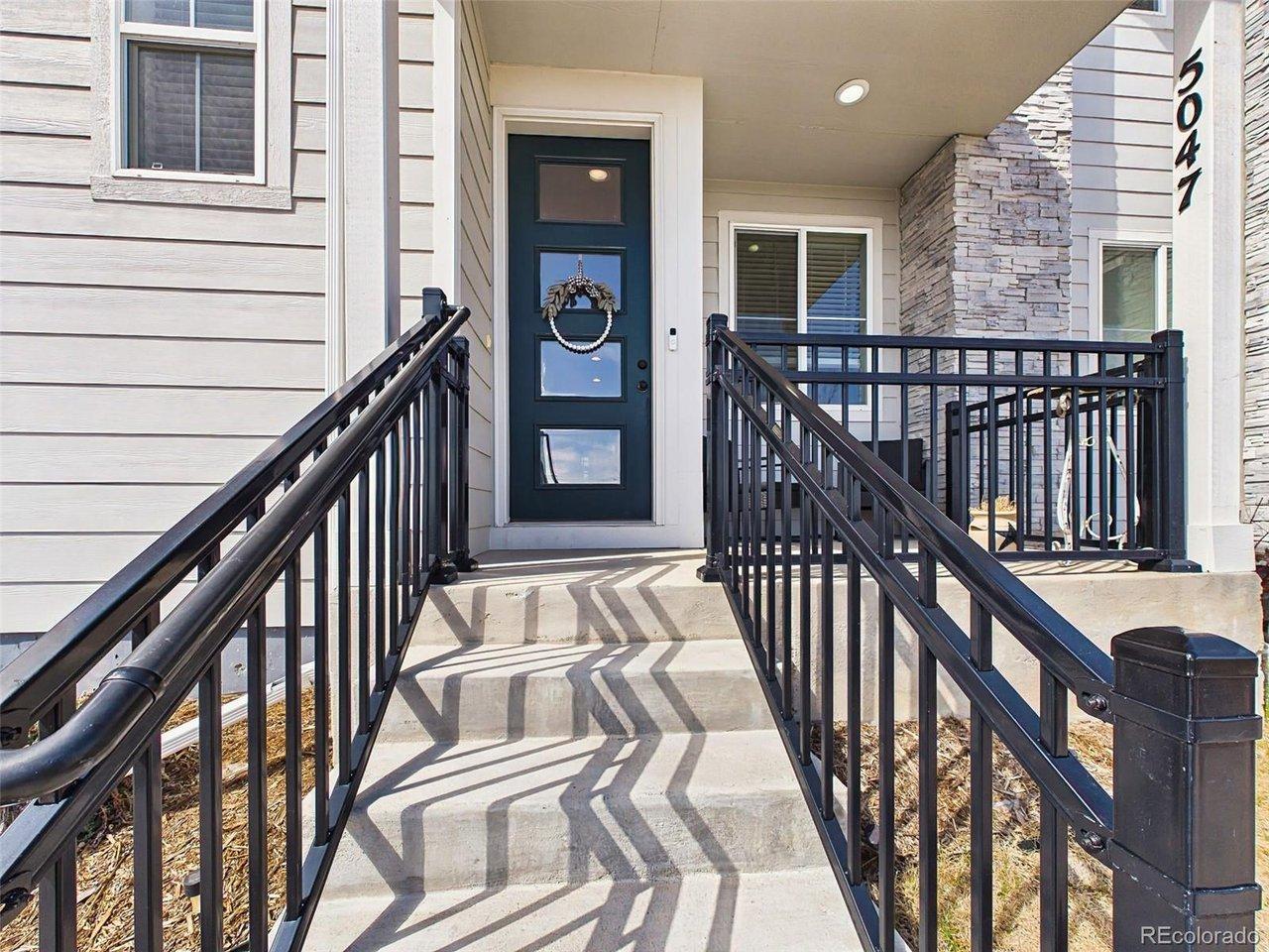 Image 4: Exterior - Covered front porch with mountain-view setting and space for outdoor seating. Image 4: Exterior - Covered front porch with mountain-view setting and space for outdoor seating.