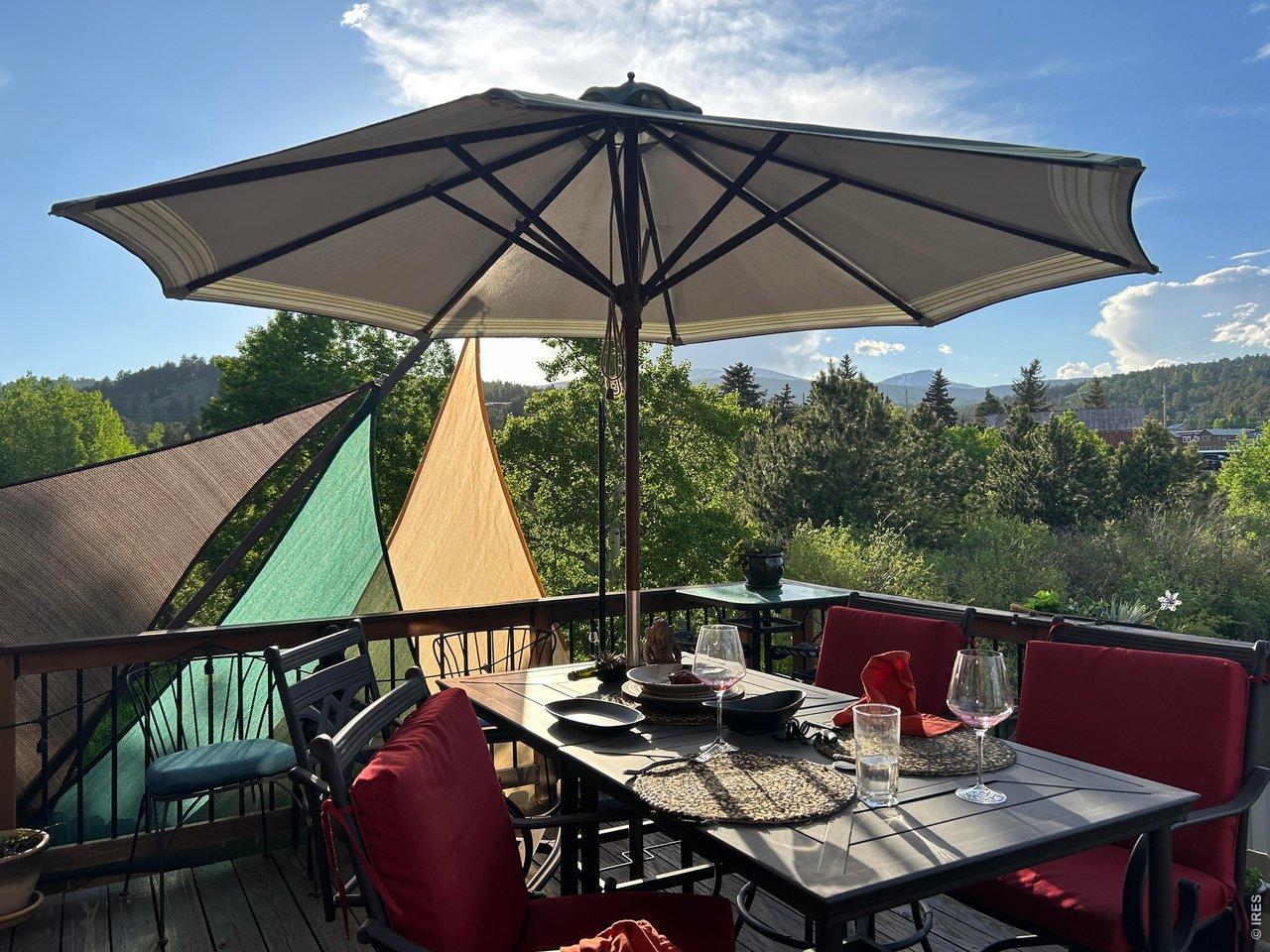 Image 2: In-town convenience with extraordinary outdoor dining deck with umbrella, table setting, and mountain views overlooking mature trees. Image 2: In-town convenience with extraordinary outdoor dining deck with umbrella, table setting, and mountain views overlooking mature trees.