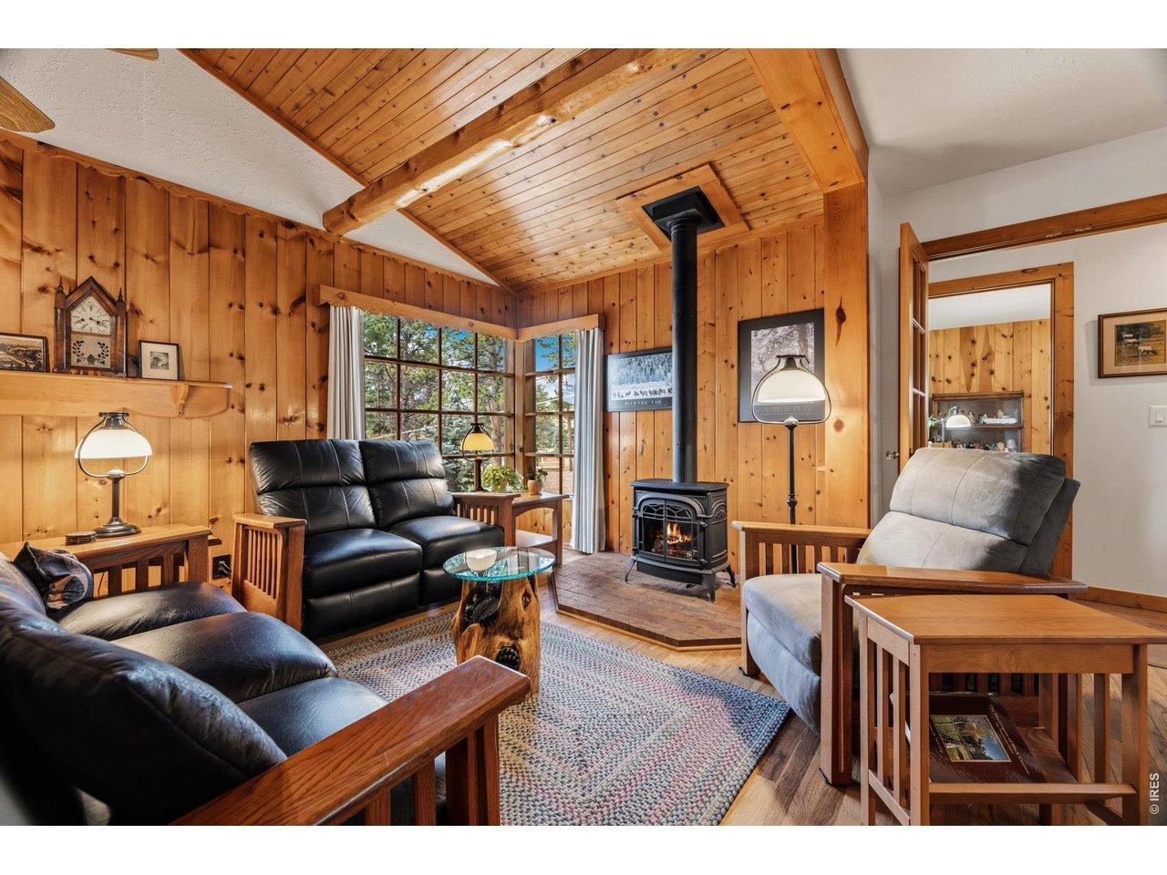 Image 3: Vaulted ceilings and pine trim in the original cabin living room Image 3: Vaulted ceilings and pine trim in the original cabin living room