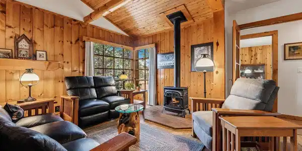 Image 3: Vaulted ceilings and pine trim in the original cabin living room Image 3: Vaulted ceilings and pine trim in the original cabin living room