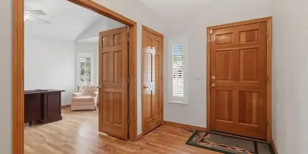 Image 4: Front door foyer with coat closet and office access. Solid wood doors throughout the home and brand new beautiful lvp floors. Image 4: Front door foyer with coat closet and office access. Solid wood doors throughout the home and brand new beautiful lvp floors.