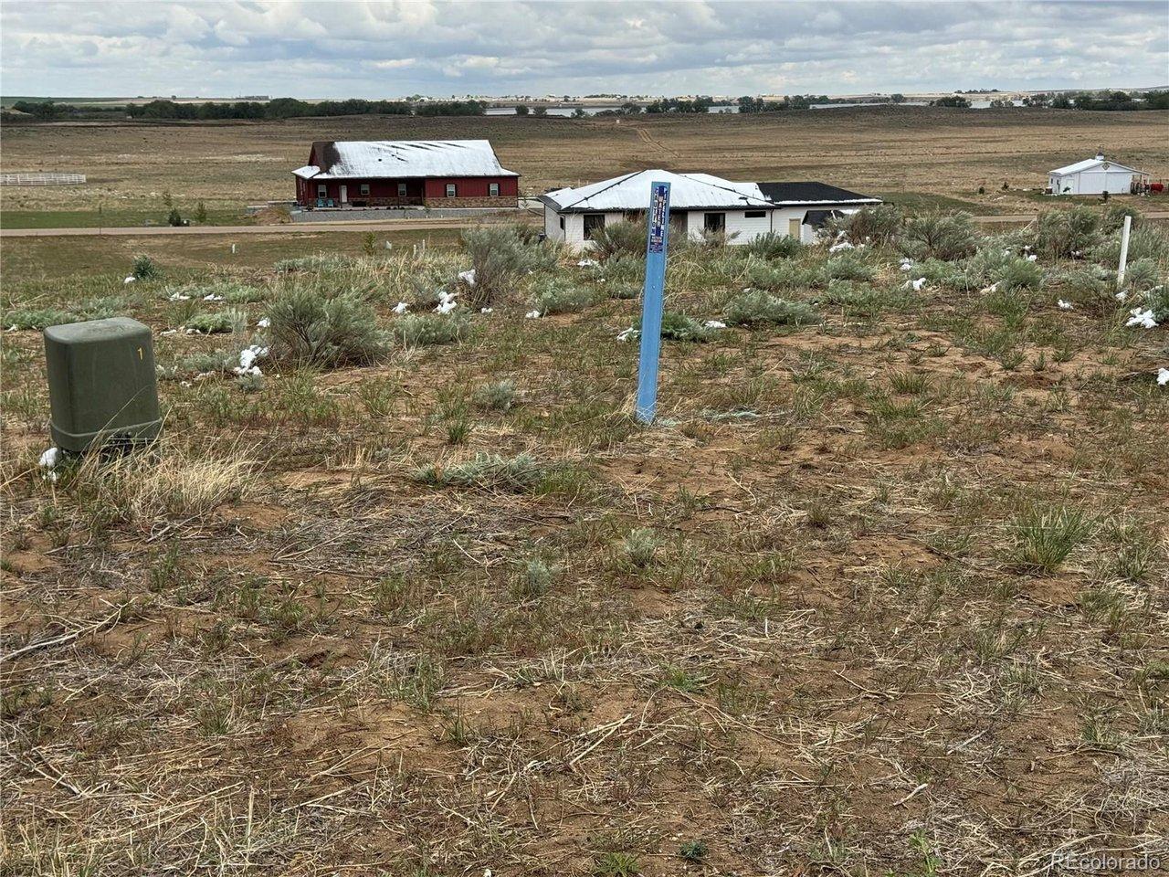 Image 4: at north property line looking east off of street. Lake in distance Image 4: at north property line looking east off of street. Lake in distance