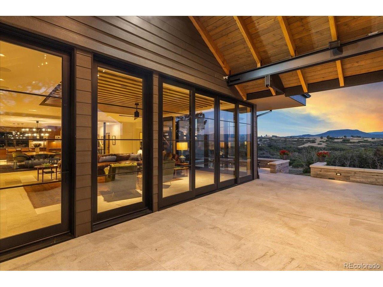 Image 2: Seamlessly blending indoor and outdoor living, expansive sliding glass doors open to a spectacular covered terrace where breathtaking Rocky Mountain views create the perfect backdrop for entertaining or relaxing year-round. Image 2: Seamlessly blending indoor and outdoor living, expansive sliding glass doors open to a spectacular covered terrace where breathtaking Rocky Mountain views create the perfect backdrop for entertaining or relaxing year-round.