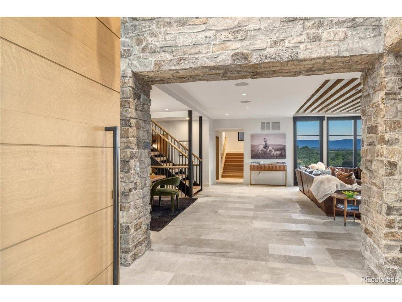 Image 3: A dramatic stone-lined gallery creates a grand transition into the heart of the home, offering a striking first impression and drawing your eye to the spectacular living spaces beyond. Image 3: A dramatic stone-lined gallery creates a grand transition into the heart of the home, offering a striking first impression and drawing your eye to the spectacular living spaces beyond.