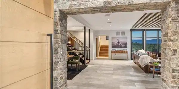 Image 3: A dramatic stone-lined gallery creates a grand transition into the heart of the home, offering a striking first impression and drawing your eye to the spectacular living spaces beyond. Image 3: A dramatic stone-lined gallery creates a grand transition into the heart of the home, offering a striking first impression and drawing your eye to the spectacular living spaces beyond.