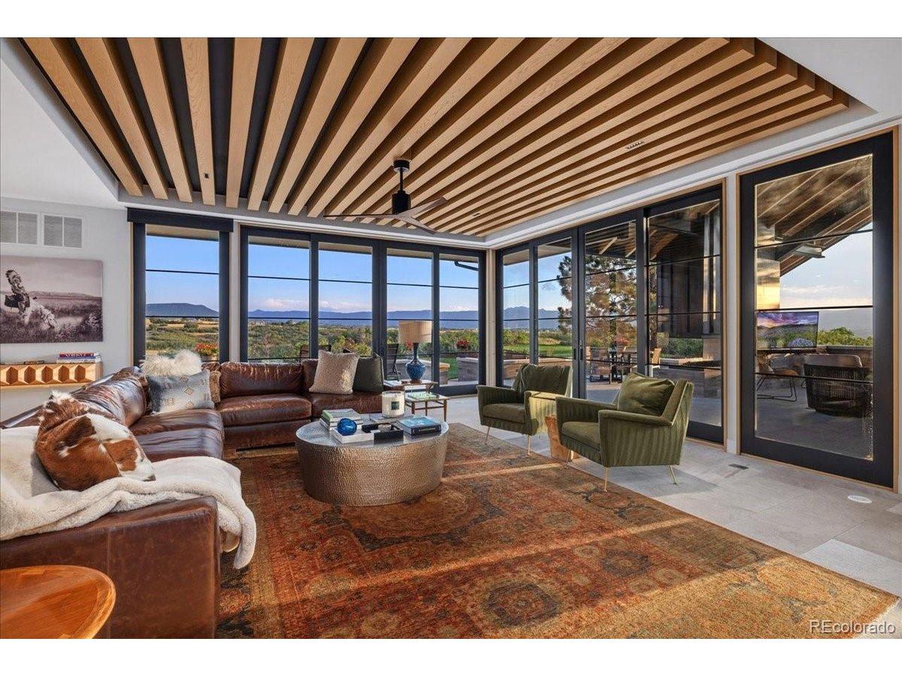 Image 4: The stunning Great Room showcases soaring ceilings with custom white oak beams, walls of glass, and panoramic mountain views that blur the line between indoors and out. Image 4: The stunning Great Room showcases soaring ceilings with custom white oak beams, walls of glass, and panoramic mountain views that blur the line between indoors and out.