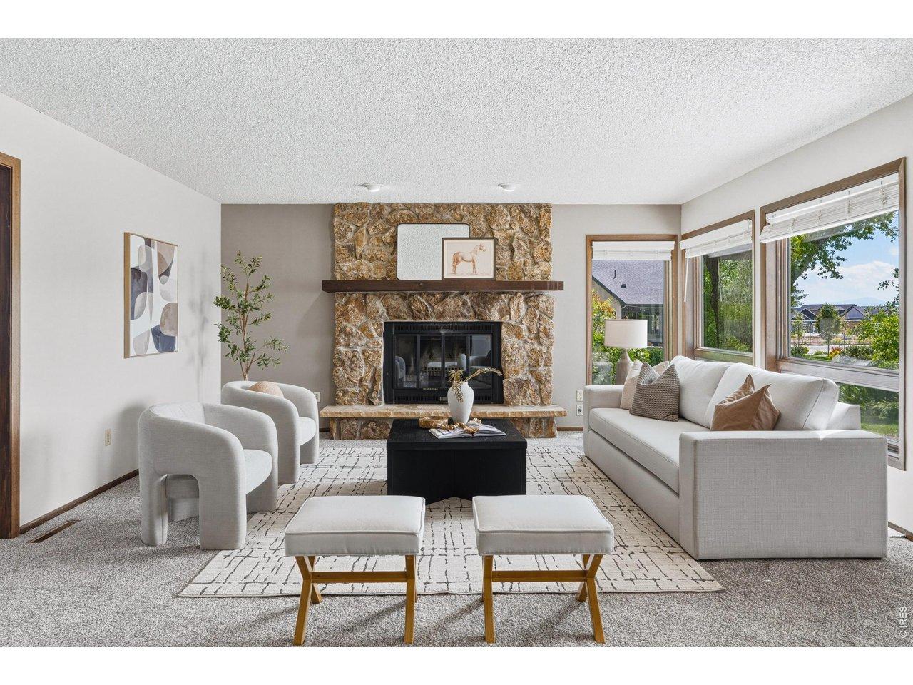 Image 4: Light-filled living room anchored by a beautiful stone fireplace. Image 4: Light-filled living room anchored by a beautiful stone fireplace.