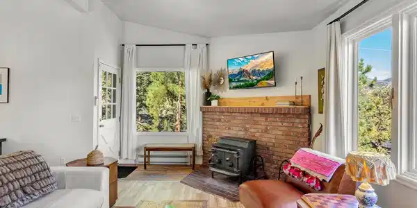 Image 3: Living room featuring a wood-burning fireplace