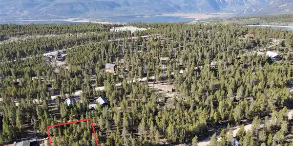 Image 4: Aerial view of property and surrounding area featuring property parcel outlined and a water and mountain view Image 4: Aerial view of property and surrounding area featuring property parcel outlined and a water and mountain view