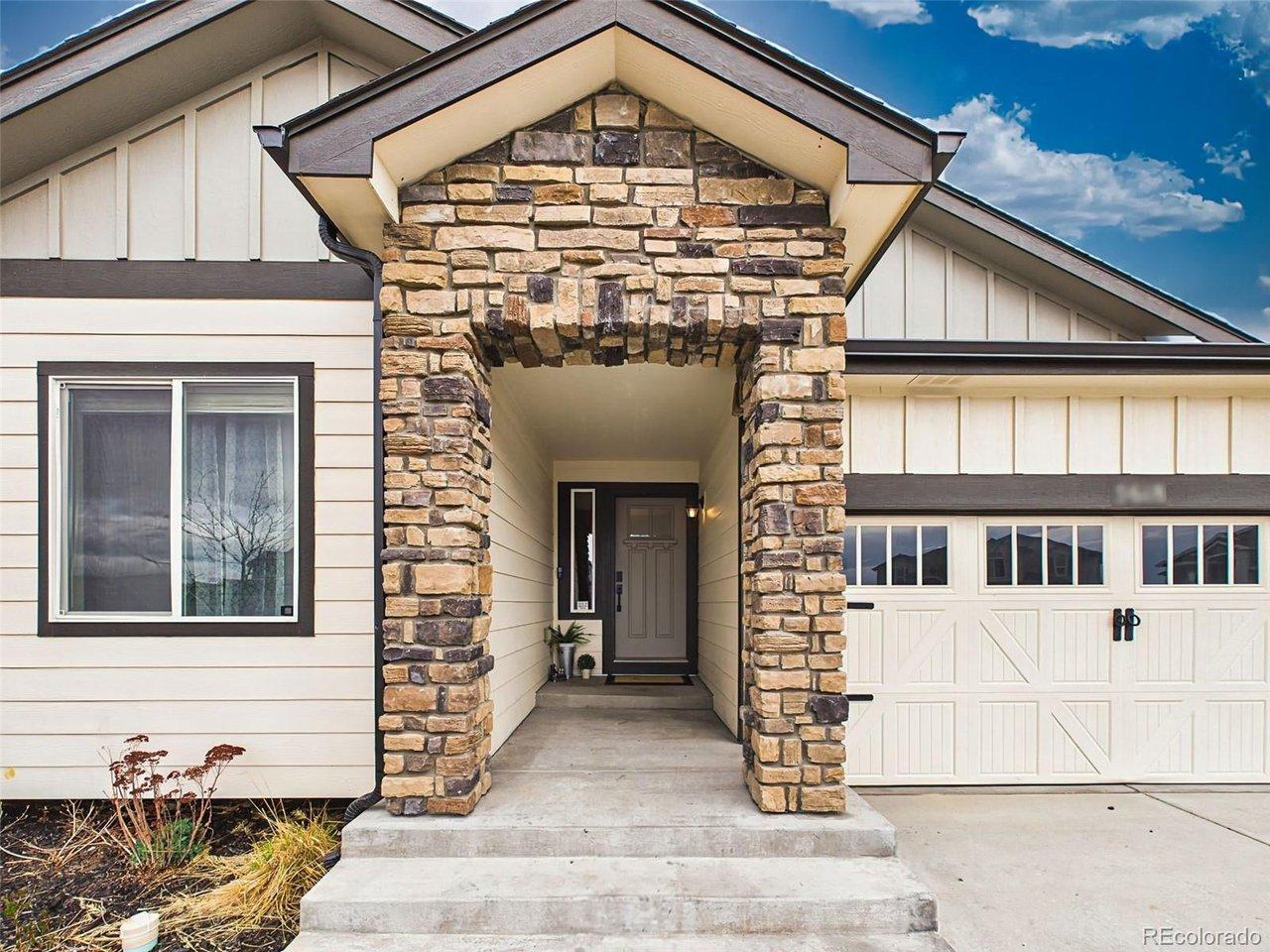 Image 2: Inviting covered entry with stone columns and sheltered front door approach. Image 2: Inviting covered entry with stone columns and sheltered front door approach.