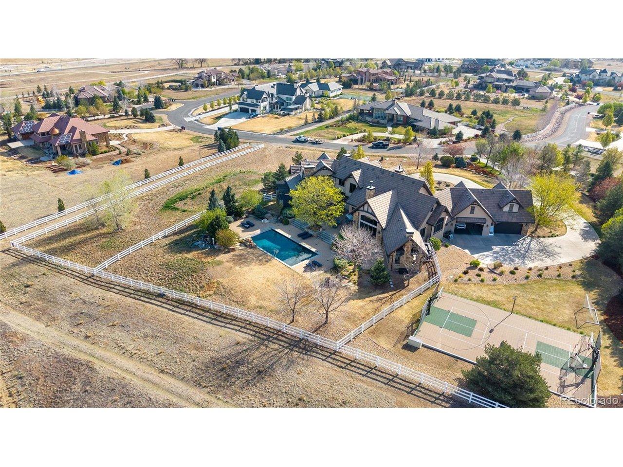 Image 2: 2.63 acre Estate Home with Unmatched Mountain Views, Aerial views highlight the impressive scale of the grounds backing to Broomfield County Open Space, including the sports court, sun-drenched pool, and vast open acreage.
