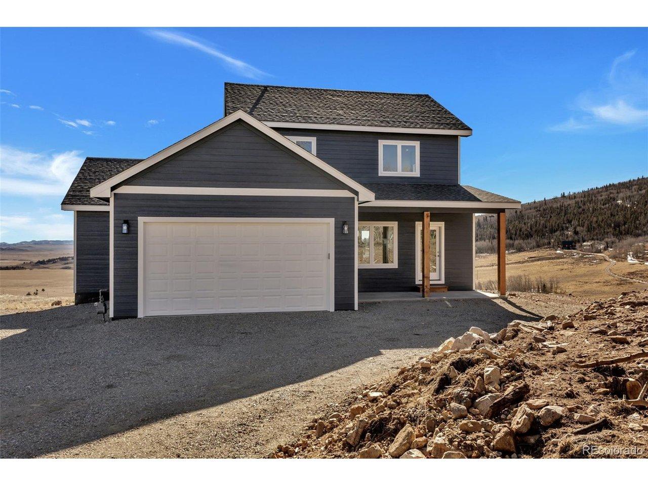 Image 1: Curb appeal meets mountain-modern sophistication; this striking new construction features a bold, deep-slate palette and natural timber accents, perfectly situated to capture the vast Colorado horizons.