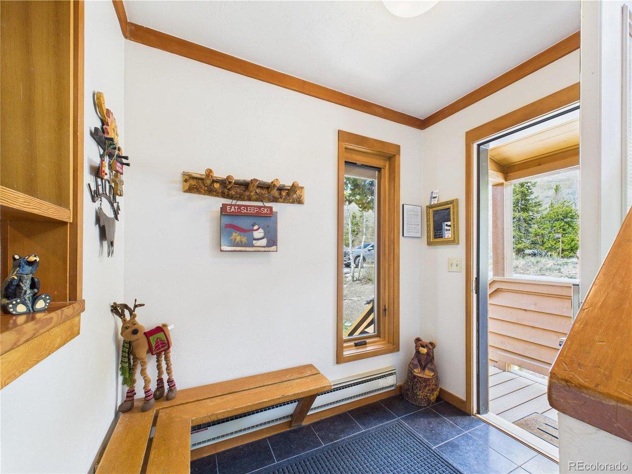 Image 4: Functional entry space with bench seating and ski gear hooks.