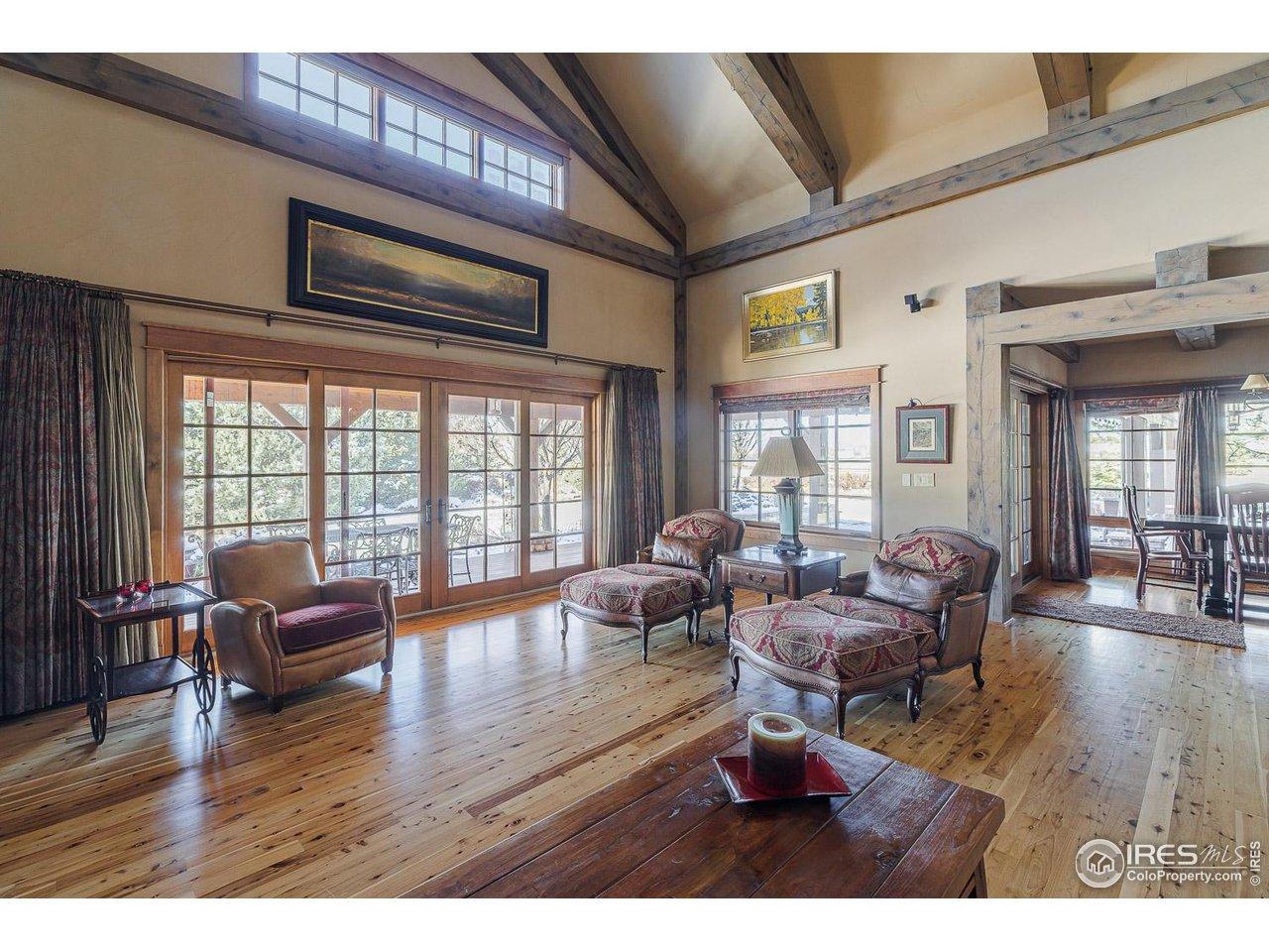 Image 4: Soaring ceilings, dramatic stone fireplace & expansive sun-filled spaces Image 4: Soaring ceilings, dramatic stone fireplace & expansive sun-filled spaces