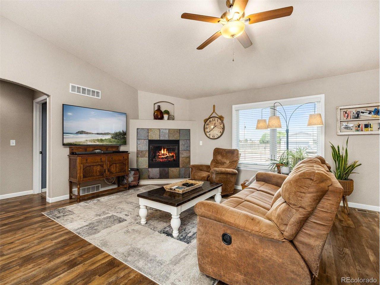 Image 4: This stunning rancher has an open floor plan with LVP flooring in the main areas, gas fireplace and upgraded kitchen with custom cabinets, granite counter tops and stainless appliances