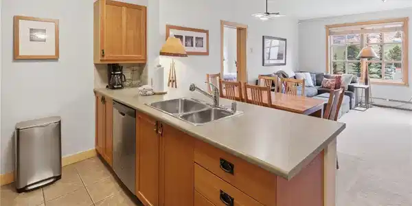Image 3: Kitchen featuring wood cabinetry, a double basin stainless steel sink, and stainless steel appliances Image 3: Kitchen featuring wood cabinetry, a double basin stainless steel sink, and stainless steel appliances