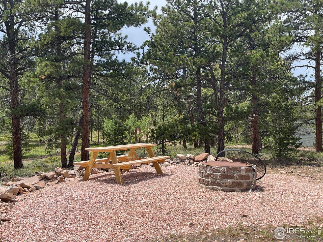 Image 3: Well graveled firepit & picnic area. Image 3: Well graveled firepit & picnic area.