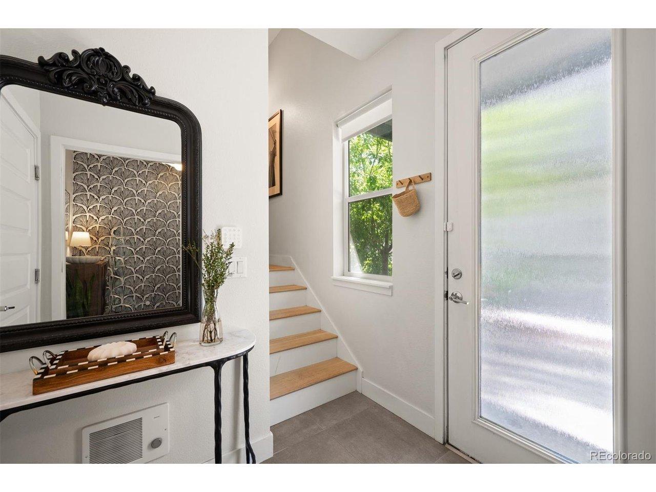 Image 3: Entryway with front door and garage access. Image 3: Entryway with front door and garage access.