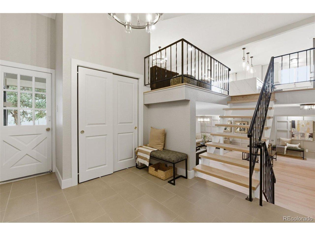 Image 4: Striking entry with modern staircase, warm wood flooring, and abundant natural light. Image 4: Striking entry with modern staircase, warm wood flooring, and abundant natural light.