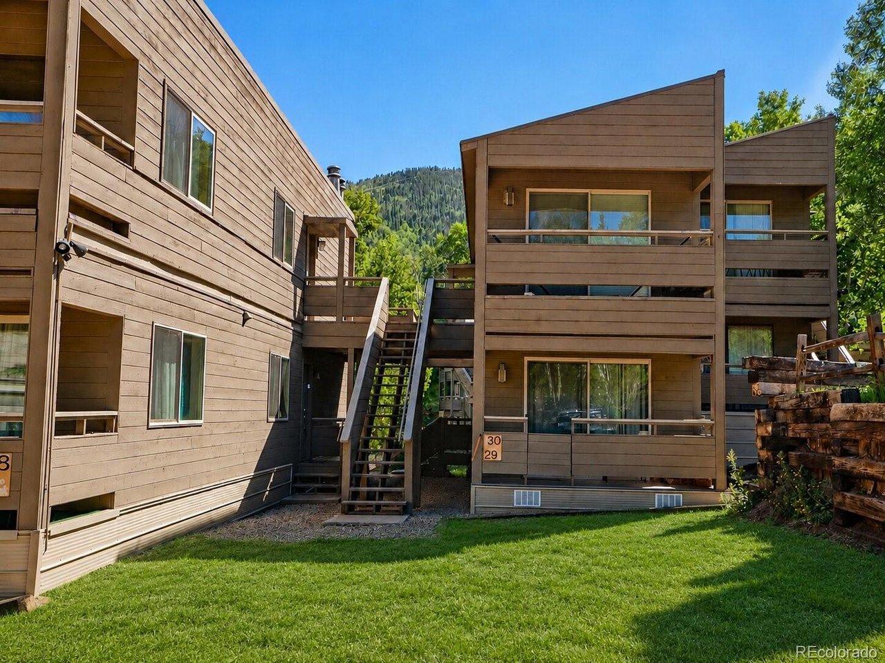 Image 3: Front of Condo Building; Ground cover AI enhanced
