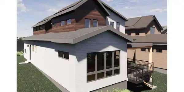 Image 4: The rear elevation showcases seamless indoor outdoor living with expansive windows and direct access to the covered back deck. Enjoy natural light, privacy, and a peaceful setting ideal for everyday relaxation or entertaining.